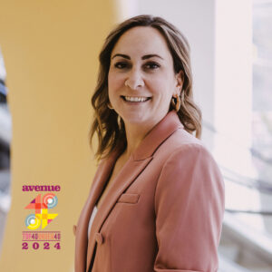 Founder of CEC, Marcie, headshot smiling and wearing pink blazer