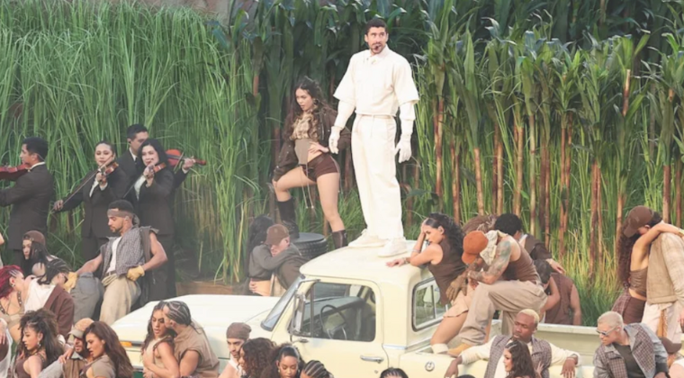 Bad Bunny at Super Bowl Half Time Show standing on top of a white pick up truck surrounded by dancers