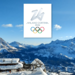 Milano Olympics Rings against a snowy mountain and a cottage