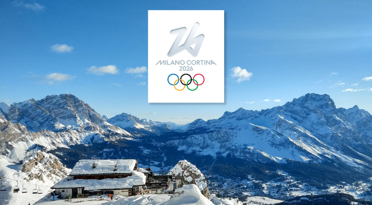 Milano Olympics Rings against a snowy mountain and a cottage