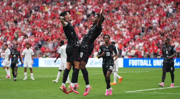 Football players celebrating a goal during an international soccer tournament, highlighting teamwork, achievement, and a shared sense of belonging.