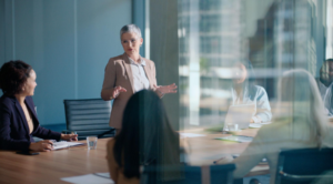 Business people, leader and woman in a meeting, presentation and boardroom