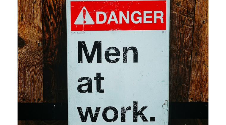 Men at work warning sign representing conversations about masculinity, antifeminism and workplace culture