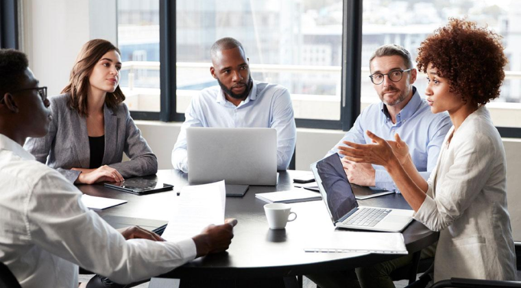 Diverse team discussing workplace culture, harassment prevention and employee safety during a meeting